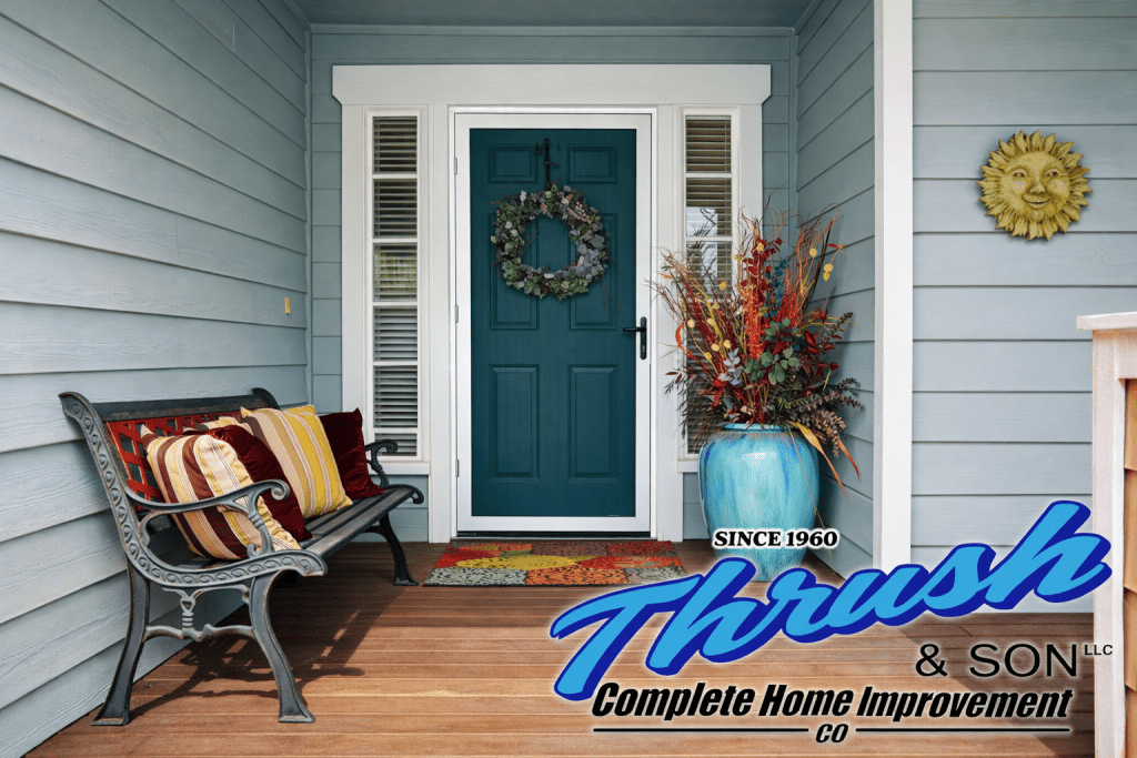 Front porch featuring a decorative steel storm door with bench seating, seasonal planter, and welcoming home entry design